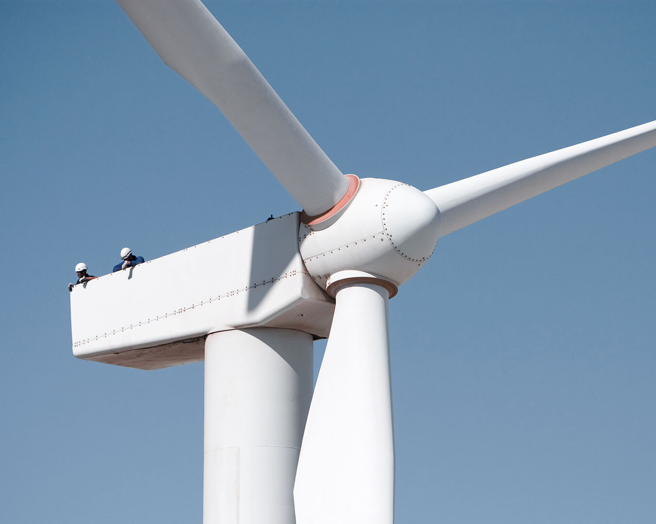 Refinery with sea in foreground and sunrise in background
