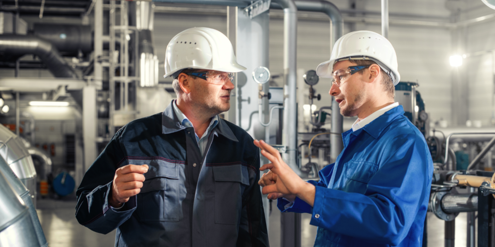 two men discussing in front of a machine